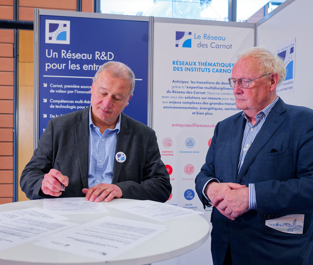 Aymeric Penven accompagné de quelqu'un qui consulte des documents sur une table